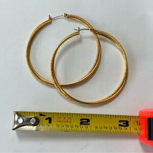 Large, vintage gold tone pierced hoop earrings